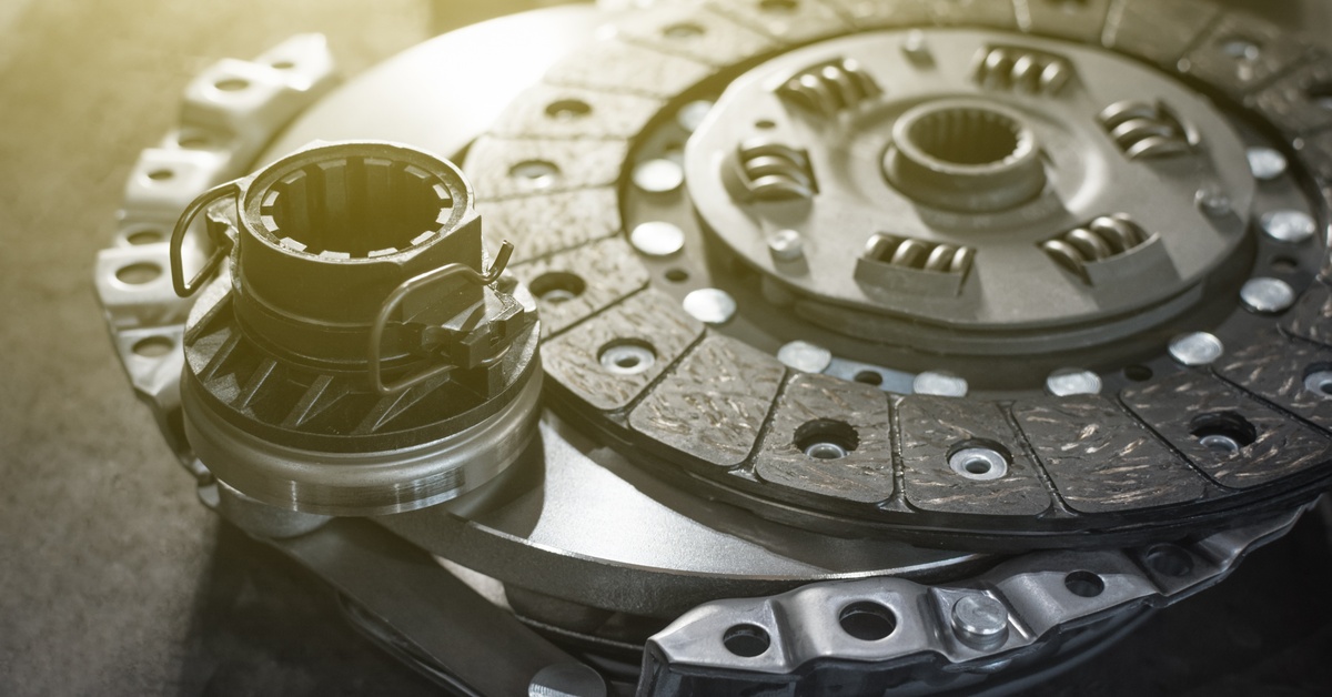 A brand-new automotive aftermarket clutch kit, before installation, including a new clutch disc and release bearing.