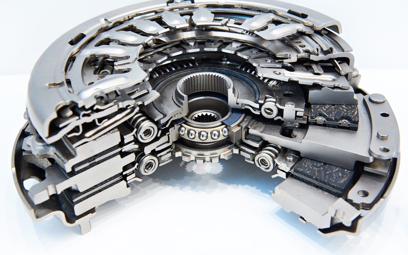 A close-up of a double disc clutch system in section to show the interior structure against a white background.