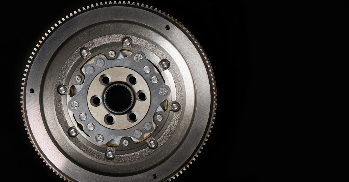 A close-up of the front of a dual-mass automotive flywheel for performance cars against a black background.