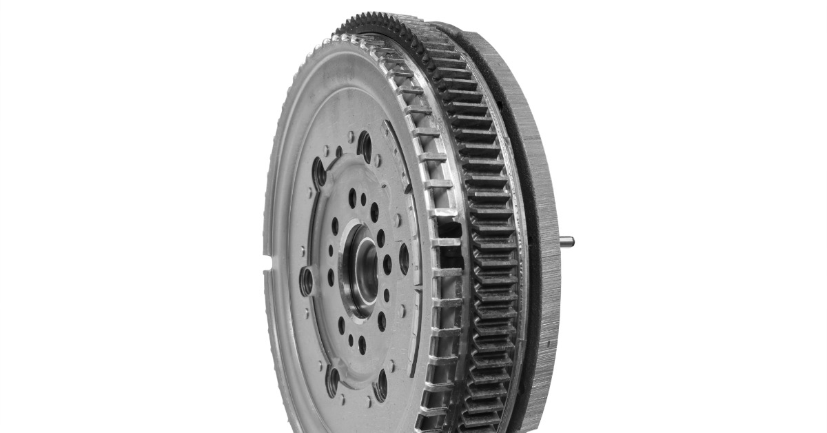 A close-up of the side of an upright automotive clutch flywheel assembly against a blank white background.