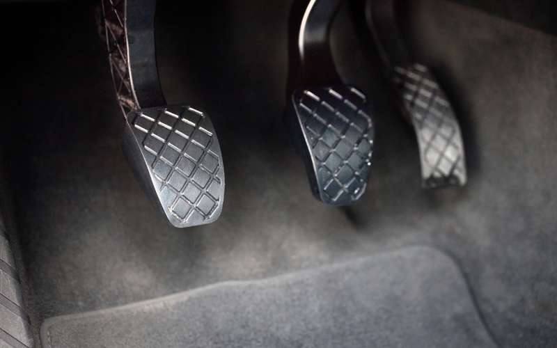 The underfloor compartment of the driver's seat in a modern car contains the clutch, brake, and accelerator pedals.