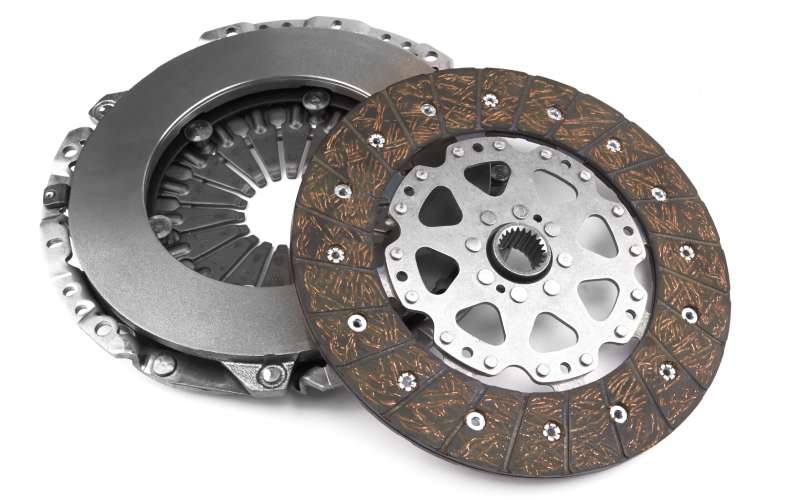 The two main components of an automotive clutch, including the clutch disc, are isolated against a white background.