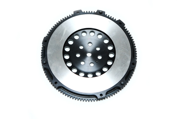 A brand-new automotive lightweight single-mass flywheel isolated against an empty, white background.