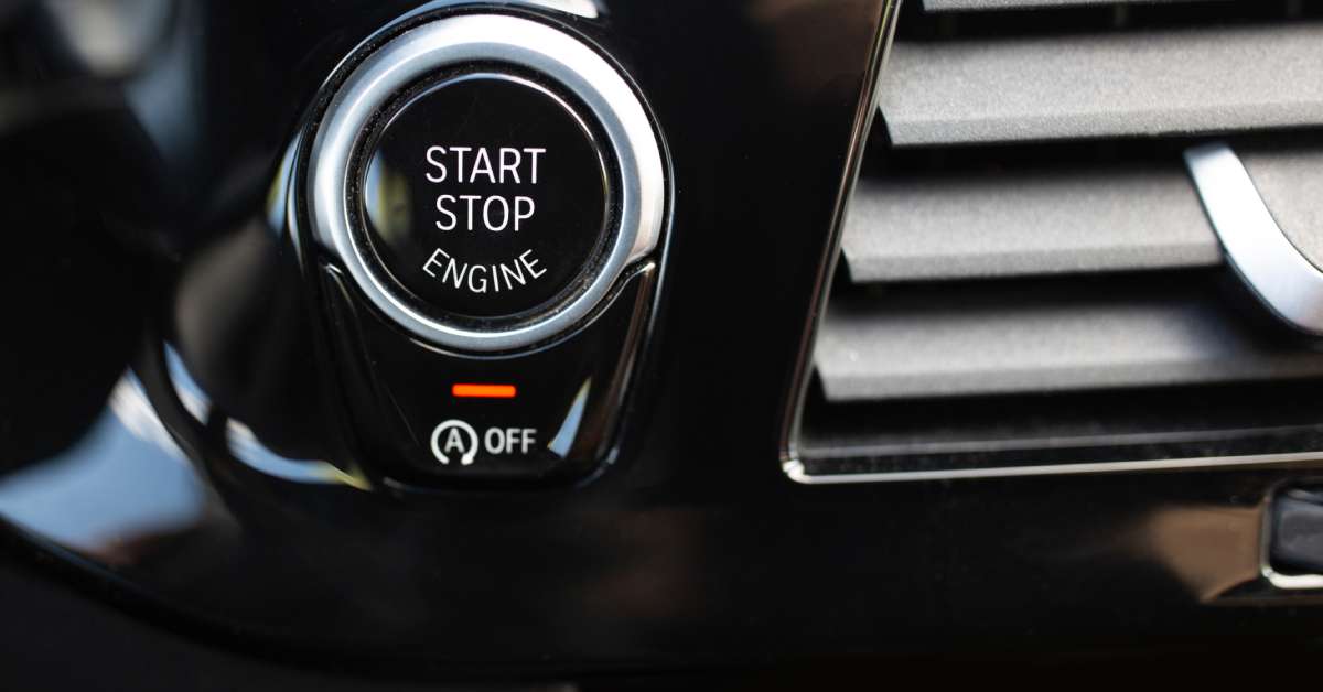 The "Start/Stop Engine" button of a luxury car with the light for the auto start/stop system activated to show it's off.